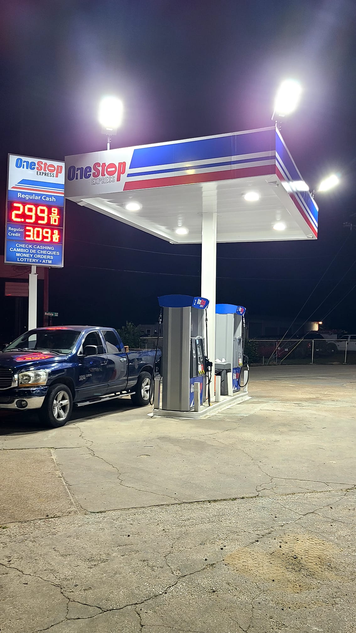 Gas station canopy and convenience store signs lit at night