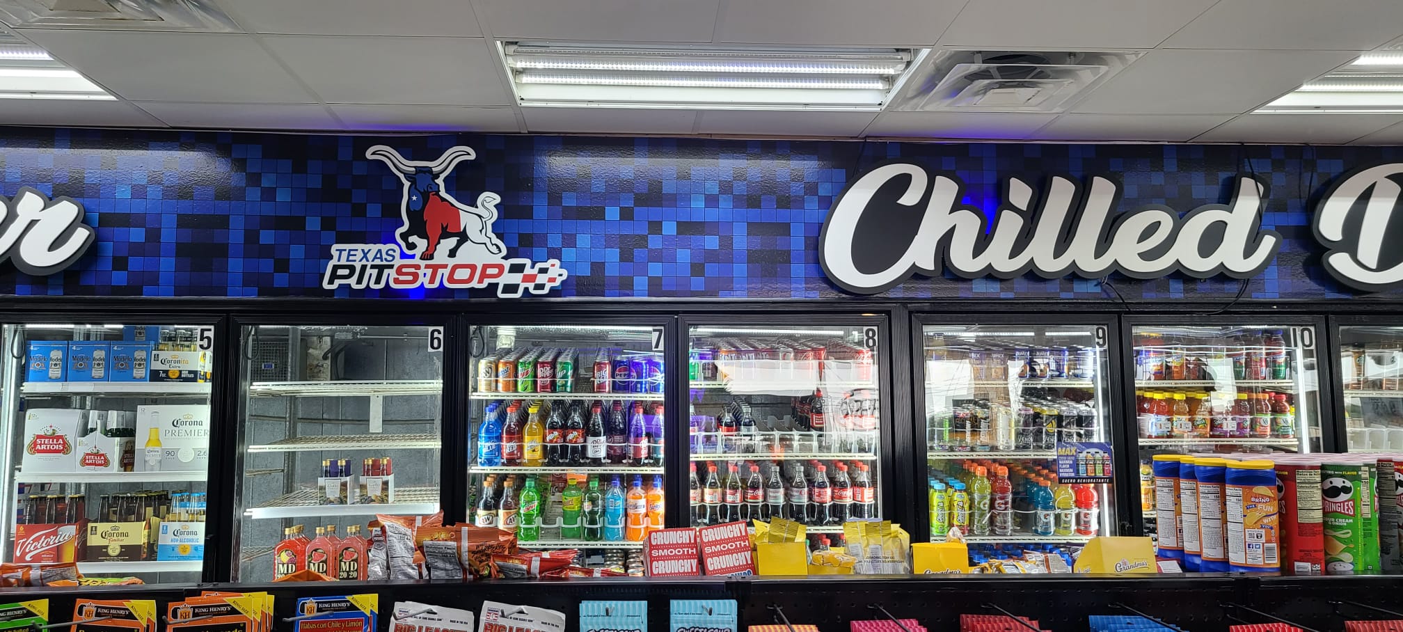 Indoor convenience store signage with dimensional cooler letters and wall graphics
